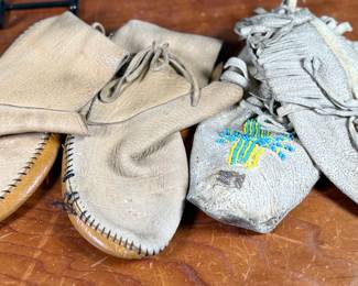 This lot features a pair of what appear to be antique Native American moccasins, consistent with styles produced in the 19th century by Plains tribes.