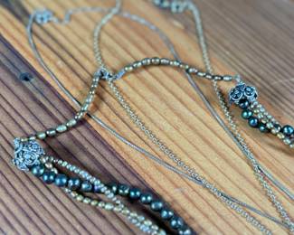 This lot features three (3) sterling silver necklaces with pieces including jade, pearls, and more. Total approx. weight of 46.91 grams.