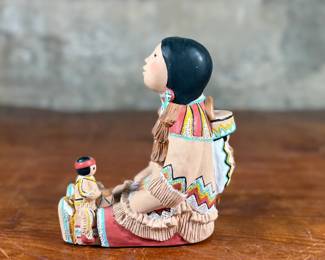 This lot features an Indian storyteller sculpture by listed artist, Cleo Teissedre circa 1990s. This sculpture measures, 6.5” H.