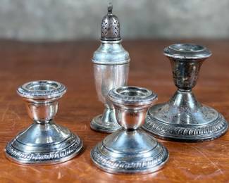 This lot features a collection of four (4) antique weighted sterling silver items with a total approx. weight of 700.00 grams.