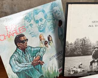 This lot features a large collection of twenty-six (26) vinyl records including artists Barbara Streisand, Aretha Franklin, Ray Charles, George Harrison, and many others.
