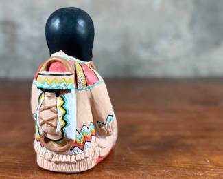 This lot features an Indian storyteller sculpture by listed artist, Cleo Teissedre circa 1990s. This sculpture measures, 6.5” H.