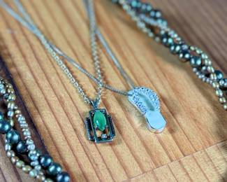 This lot features three (3) sterling silver necklaces with pieces including jade, pearls, and more. Total approx. weight of 46.91 grams.