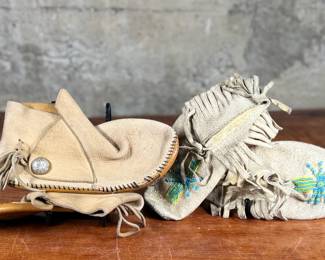 This lot features a pair of what appear to be antique Native American moccasins, consistent with styles produced in the 19th century by Plains tribes.