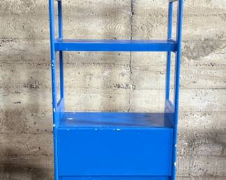 This lot features a two (2) piece wooden book or bar cart on casters with a fold down shelf. This cabinet measures, 65” H x 29.5” W x 19.5” D. Small crack that could be repaired on a caster as shown in photos.