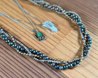 This lot features three (3) sterling silver necklaces with pieces including jade, pearls, and more. Total approx. weight of 46.91 grams.