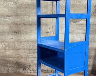 This lot features a two (2) piece wooden book or bar cart on casters with a fold down shelf. This cabinet measures, 65” H x 29.5” W x 19.5” D. Small crack that could be repaired on a caster as shown in photos.