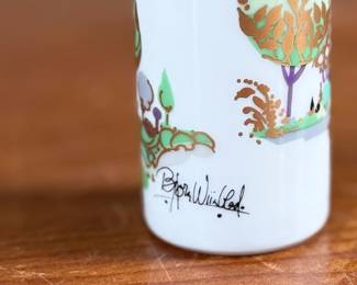 This lot features a vintage 1970s porcelain vase designed by Bjørn Wiinblad for Rosenthal Studio-Linie, featuring a whimsical colorful illustration of a harp player. Measures, 4” H and comes in excellent condition.