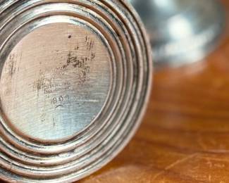 This lot features a collection of four (4) antique weighted sterling silver items with a total approx. weight of 700.00 grams.