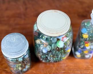 This lot features a large marble collection with three (3) containers filled!