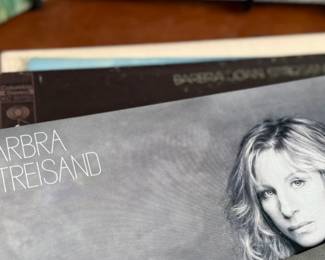 This lot features a large collection of twenty-six (26) vinyl records including artists Barbara Streisand, Aretha Franklin, Ray Charles, George Harrison, and many others.