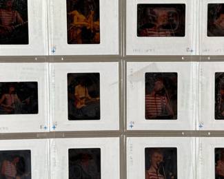 Vintage 35mm slides primarily organized in a transparent holder. Each slide features labels with the name “Richard Creamer” and addresses in Beverly Hills and Los Angeles, CA. Subjects documented include notable music acts that are believed to be Steve Winwood, Donna Summer, and others.