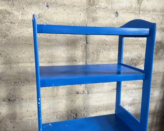 This lot features a two (2) piece wooden book or bar cart on casters with a fold down shelf. This cabinet measures, 65” H x 29.5” W x 19.5” D. Small crack that could be repaired on a caster as shown in photos.