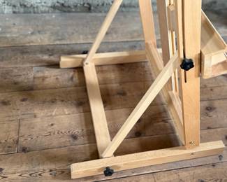 This lot features a large adjustable art studio easel made of Beechwood and in very good condition. Measures up to 6” H.