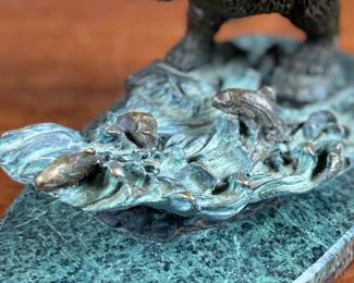 This lot features a bronze bear sculpture on a stone plinth by SPI Gallery. Signed as shown in photos and measures, 7” H x 10” W x 5” D.