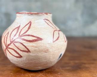 This lot features a Santo Domingo pottery pot likely circa 1920s that measures, 6” H and is in very good condition.