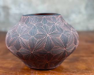 This lot features a stunning pottery vessel by listed artist, Debra Waconda. Signed underneath as shown in photos and measures, 5” H. Debra Waconda is a renowned Acoma Pueblo artist known for hand-coiling, painting, and signing fine-line black-on-white pottery, frequently featuring geometric patterns and intricate designs, with active pieces dating from the 1990s and 2000s. Her work, along with other Acoma potters such as Elizabeth Waconda, is considered authentic Native American Pueblo art.