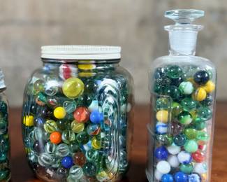 This lot features a large marble collection with three (3) containers filled!
