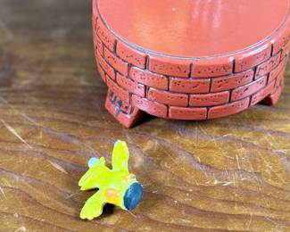 This lot features a 1976 Gorham Sesame Street Big Bird and Little Bird music box. The music box features Big Bird standing next to a “Sesame Street” signpost. It operates using a magnet mechanism that makes the small bird dance on the brick-patterned base. It was produced by the Gift World of Gorham and is in working condition.