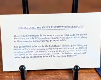 This lot features a 1971 Eisenhower uncirculated silver dollar in the original packaging.