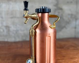 This lot features a GrowlerWerks uKeg pressurized beer growler in a copper finish. Works as it should and is in good overall condition.