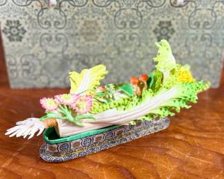 This lot features a Chinese carved and painted vegetable sculpture featuring bok choy, grasshopper, flowers, and more. Carved out of bone, quite delicate and will not be shipped in house.
