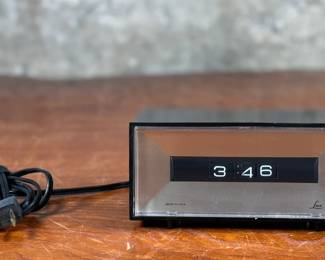 This lot features a vintage Lux electric flip clock circa 1970s in good working condition.