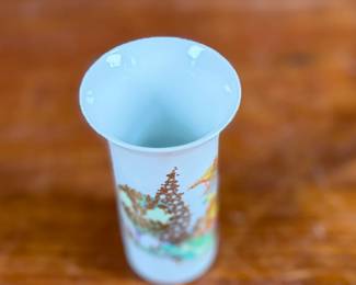 This lot features a vintage 1970s porcelain vase designed by Bjørn Wiinblad for Rosenthal Studio-Linie, featuring a whimsical colorful illustration of a harp player. Measures, 4” H and comes in excellent condition.