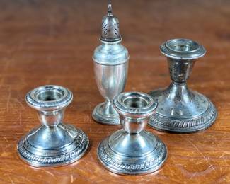This lot features a collection of four (4) antique weighted sterling silver items with a total approx. weight of 700.00 grams.