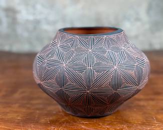 This lot features a stunning pottery vessel by listed artist, Debra Waconda. Signed underneath as shown in photos and measures, 5” H. Debra Waconda is a renowned Acoma Pueblo artist known for hand-coiling, painting, and signing fine-line black-on-white pottery, frequently featuring geometric patterns and intricate designs, with active pieces dating from the 1990s and 2000s. Her work, along with other Acoma potters such as Elizabeth Waconda, is considered authentic Native American Pueblo art.