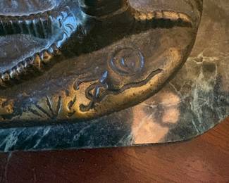 The signature on the base of the bronze Heron 