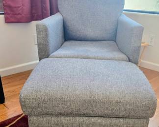 Contemporary gray upholstered chair with footrest