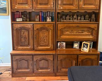 2 cabinets with carved one designs, one opens to bar 