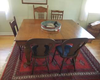 Vintage dining room table; eclectic vintage chairs; Persian rug