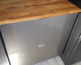 Laundry room cabinetry matches kitchen cabinets