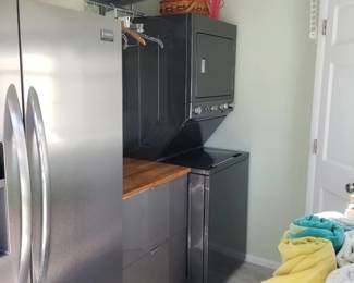 Laundry features additional kitchen cabinetry