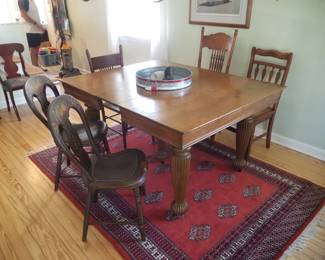 Vintage dining room table; eclectic vintage chairs; Persian rug