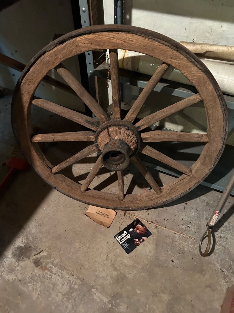 Antique wagon wheel with iron band wrapped around. 
