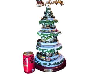 Kinkade Christmas tree with train and santa at the top