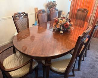 Gorgeous dining room table with eight back chairs. Has been covered. 