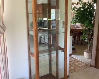 Curio cabinet with glass shelves, lighted and side doors