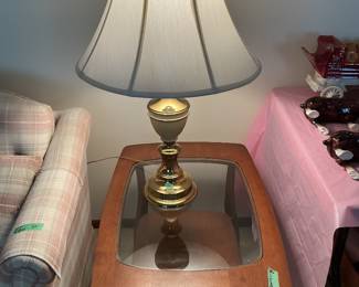 Mid century modern end table with lower shelf and glass top.  Has matching coffee table