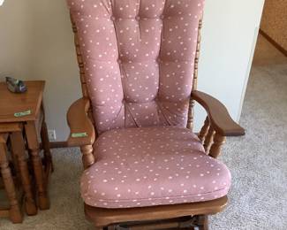 Wooden rocker with mauve fabric upholstery