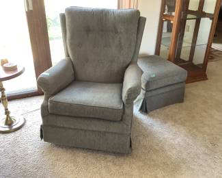 Grey chair is rocker and swivels  and comes with ottoman. Measures 38” h x 30” w x 36” d.  Ottoman is 21” sq.