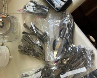 Several stainless flatware sets.