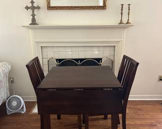 Small wood drop leaf table with two chairs.