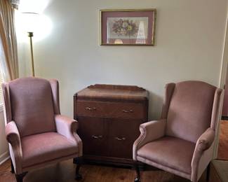 Antique chest. Two antique pink velvet chairs.