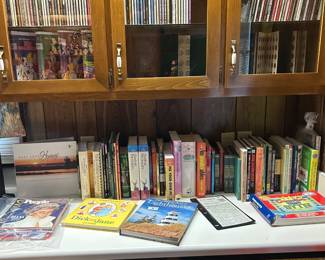 More DVD's. Collectible Black label Disney movies. Books. State quarter books. Filled.