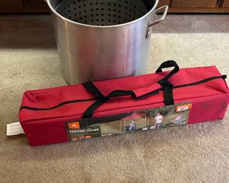 Very large stock pot and red pop up tent.