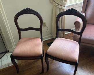 Two matching mahoghany chairs.